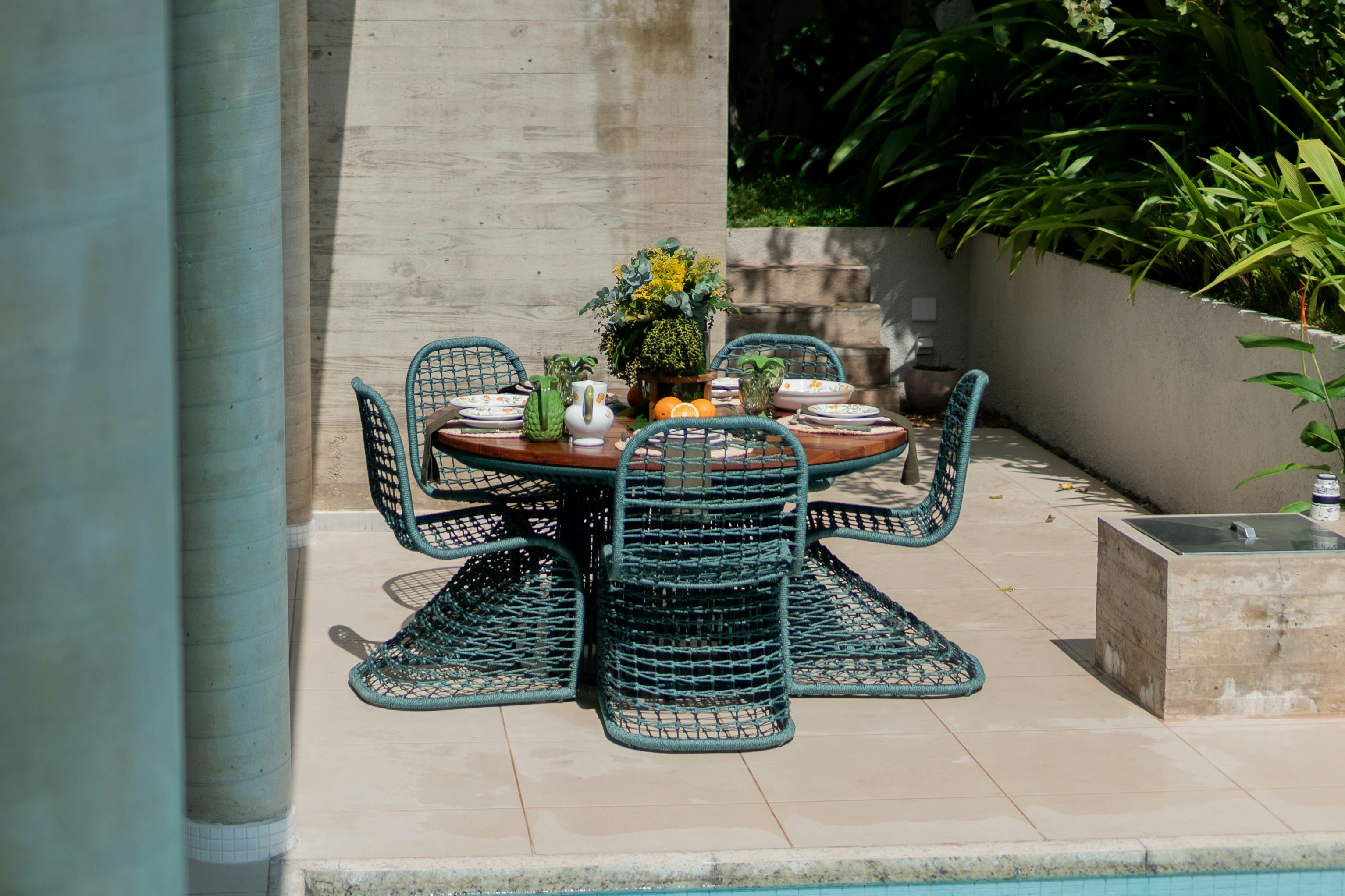 a table and chairs near a swimming pool
